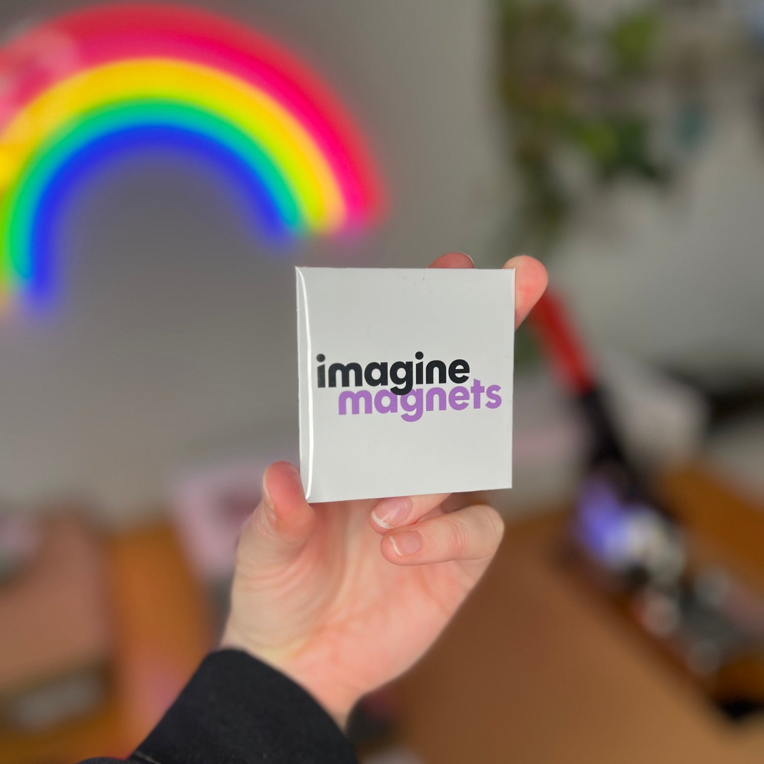 hand holding custom magnet showing a corporate logo